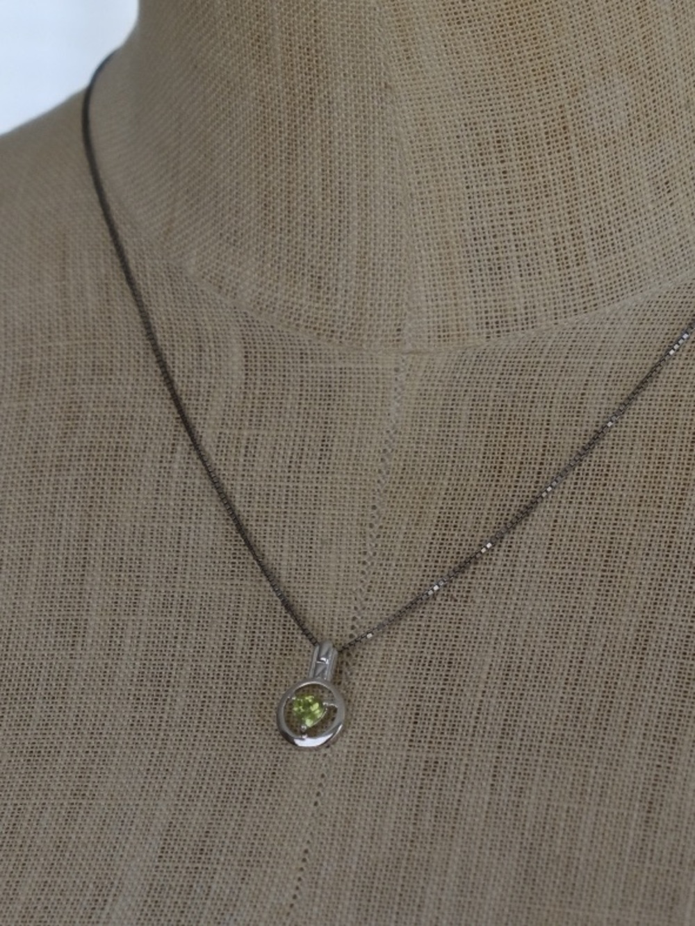 silver necklace with green stone